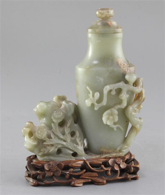 A Chinese celadon jade vase, 20th century, 17.5cm, together with a carved wood stand